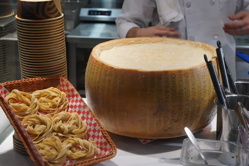 Fresh pasta beside a hollowed Parmigiano Reggiano wheel